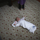 An Uighur refugee baby lies on the floor as his mother takes part in an interview with Reuters in Istanbul, Turkey.